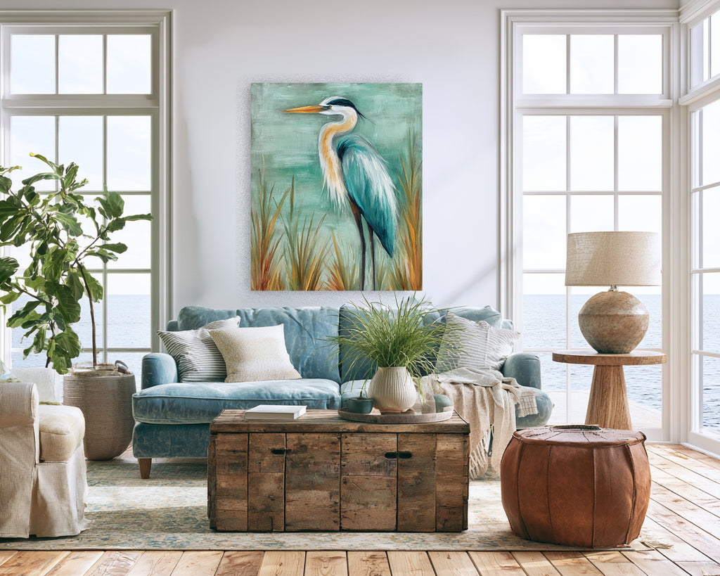 Living room with a blue sofa, wooden coffee table, and a painting of a heron on the wall.