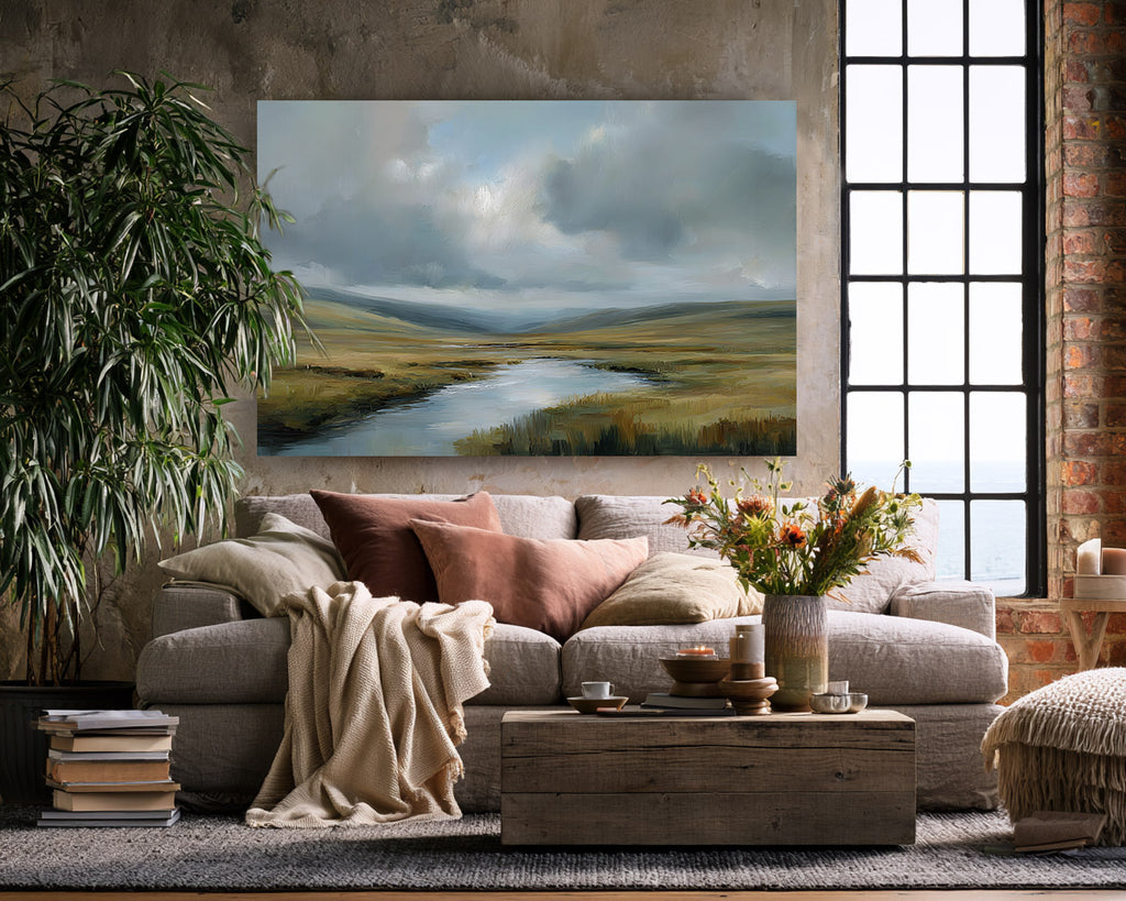 Living room with a large painting of a landscape, sofa, and coffee table.