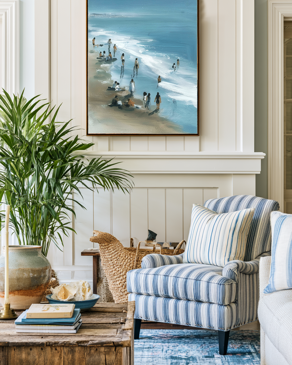 Living room with striped armchair, coffee table, and beach-themed artwork on the wall.