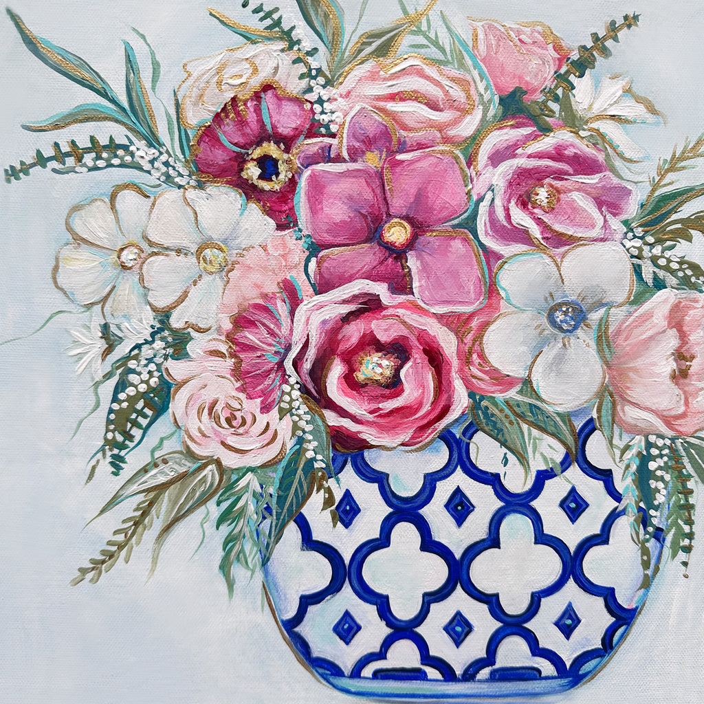 Colorful floral arrangement in a blue and white patterned vase on a light background