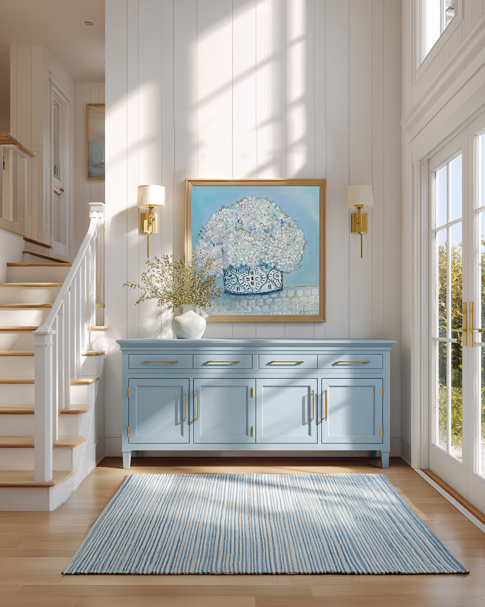 Foyer with blue cabinet, framed artwork, and light fixture