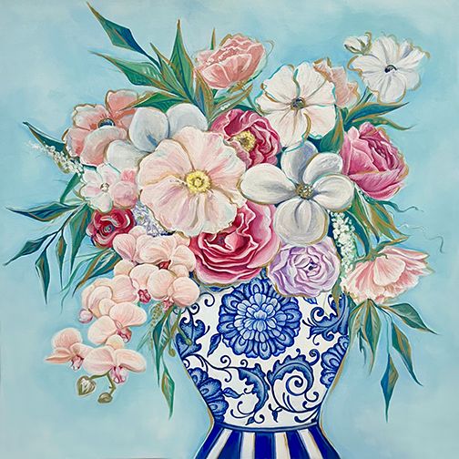 Floral arrangement in a blue and white vase on a light blue background
