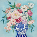 Floral arrangement in a blue and white vase on a light blue background