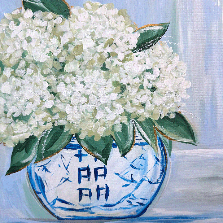 White flowers in a blue and white vase on a light background