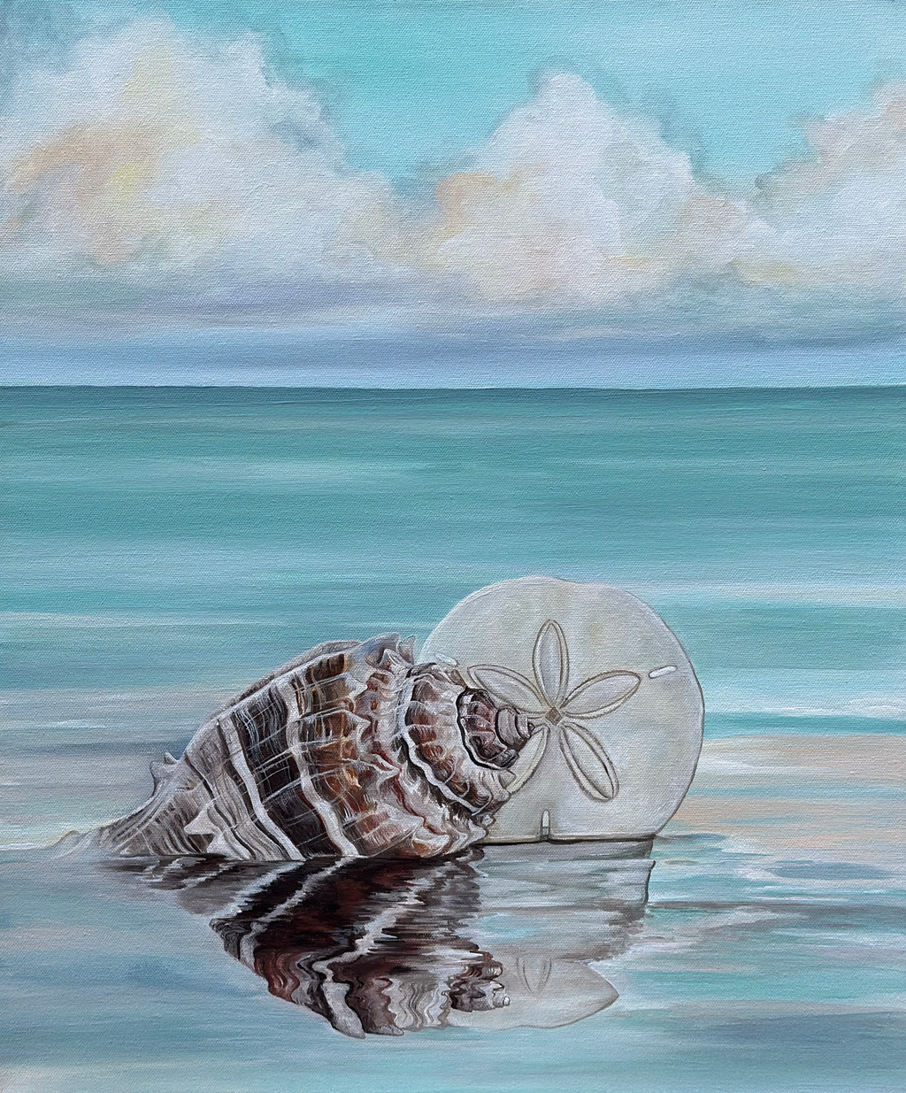 Seashell and sand dollar on a beach with ocean and sky in the background