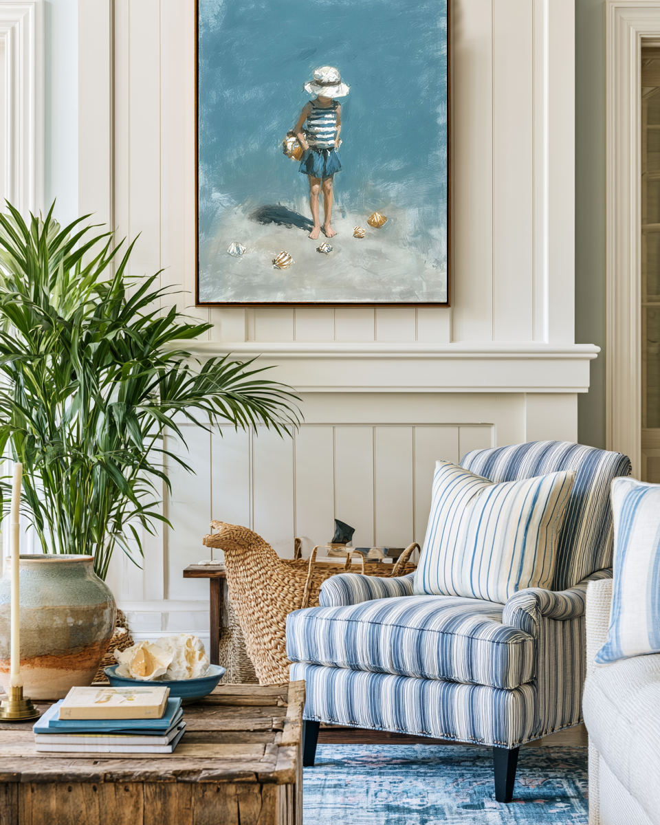 Living room with striped armchair, coffee table, and decorative painting on the wall.